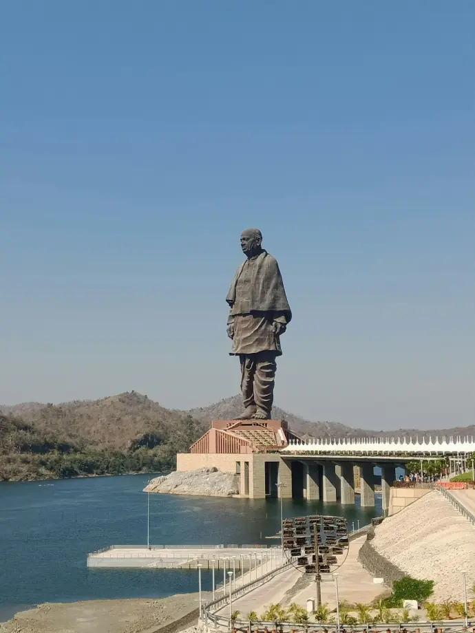 a large statue of a man standing on top of a bridge